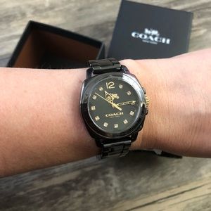 Coach watch in black ceramic with gold details.